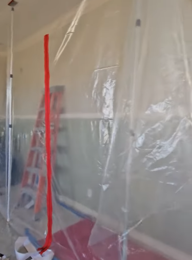 Plastic containment sheeting set up during a fire and water damage restoration project in Bellingham, Washington.
