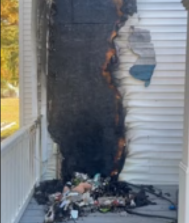 Burnt exterior siding and porch debris after a house fire in a Bellingham, Washington home.
