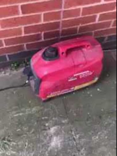 Portable sewage cleanup equipment placed on grass outside property during service
