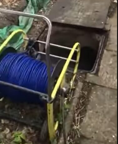 Utility lines exposed in dirt crawlspace affected by sewage contamination