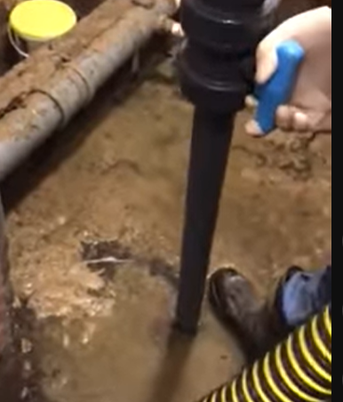 Sewer pipe excavation showing dirt and plumbing during sewage system repair